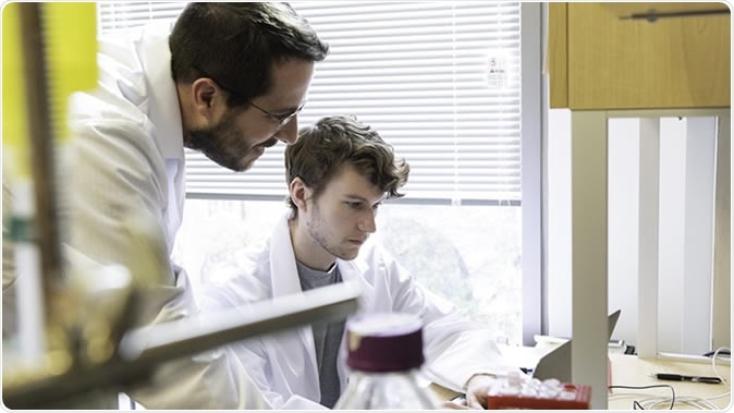 Jason S. McLellan, associate professor of molecular biosciences, left, and graduate student Daniel Wrapp, right, work in the McLellan Lab at The University of Texas at Austin Monday Feb. 17, 2020. Credit: Vivian Abagiu/Univ. of Texas at Austin.