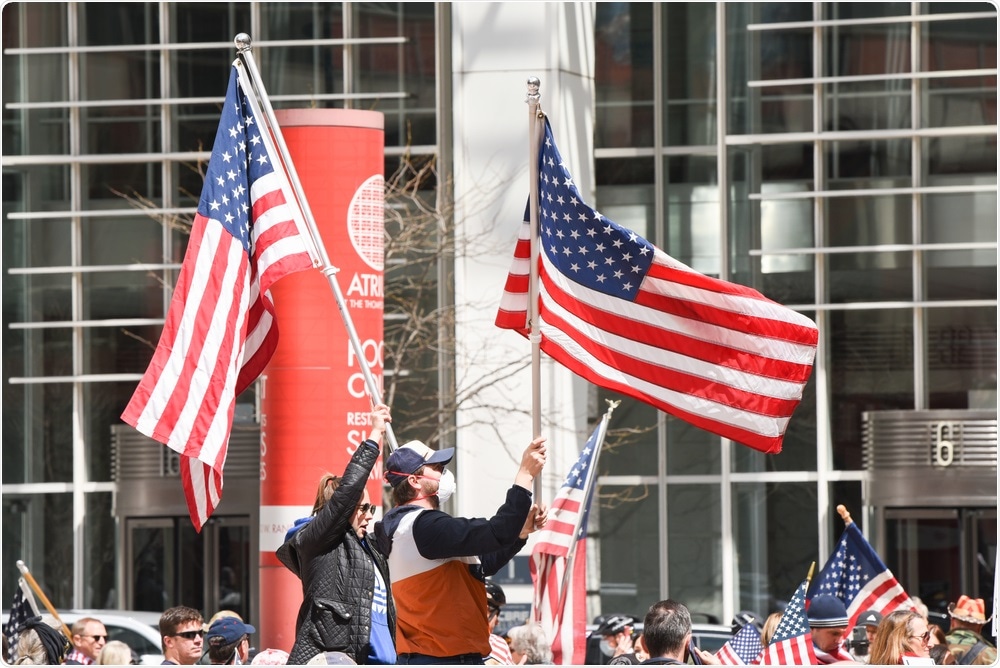 Civil protest in Downtown Chicago against the restrictions placed upon the citizens. Image Credit: Kevin Kipper / Shutterstock