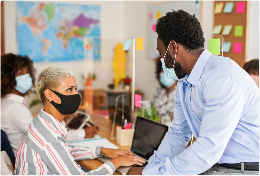 People speaking while wearing masks
