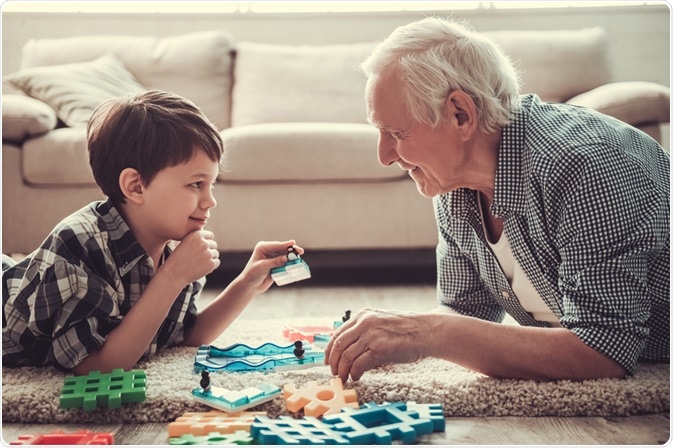 Boy playing with his grandfather