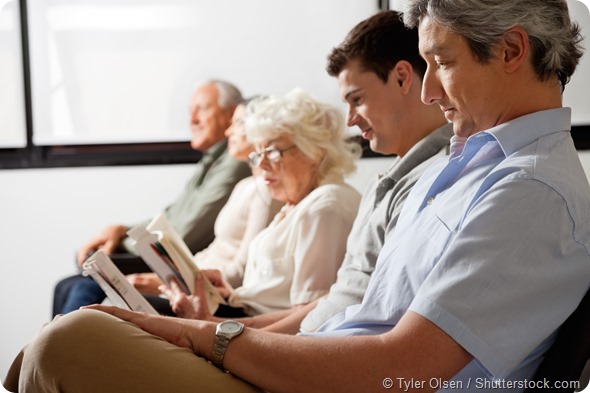 Row of multiethnic people waiting for the doctor in hospital lobby
