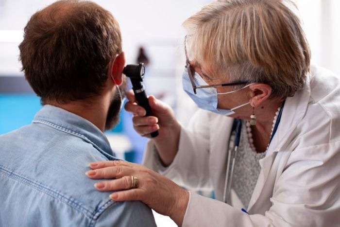 Clinician Utilizing an Ear Endoscope for Patient Examination