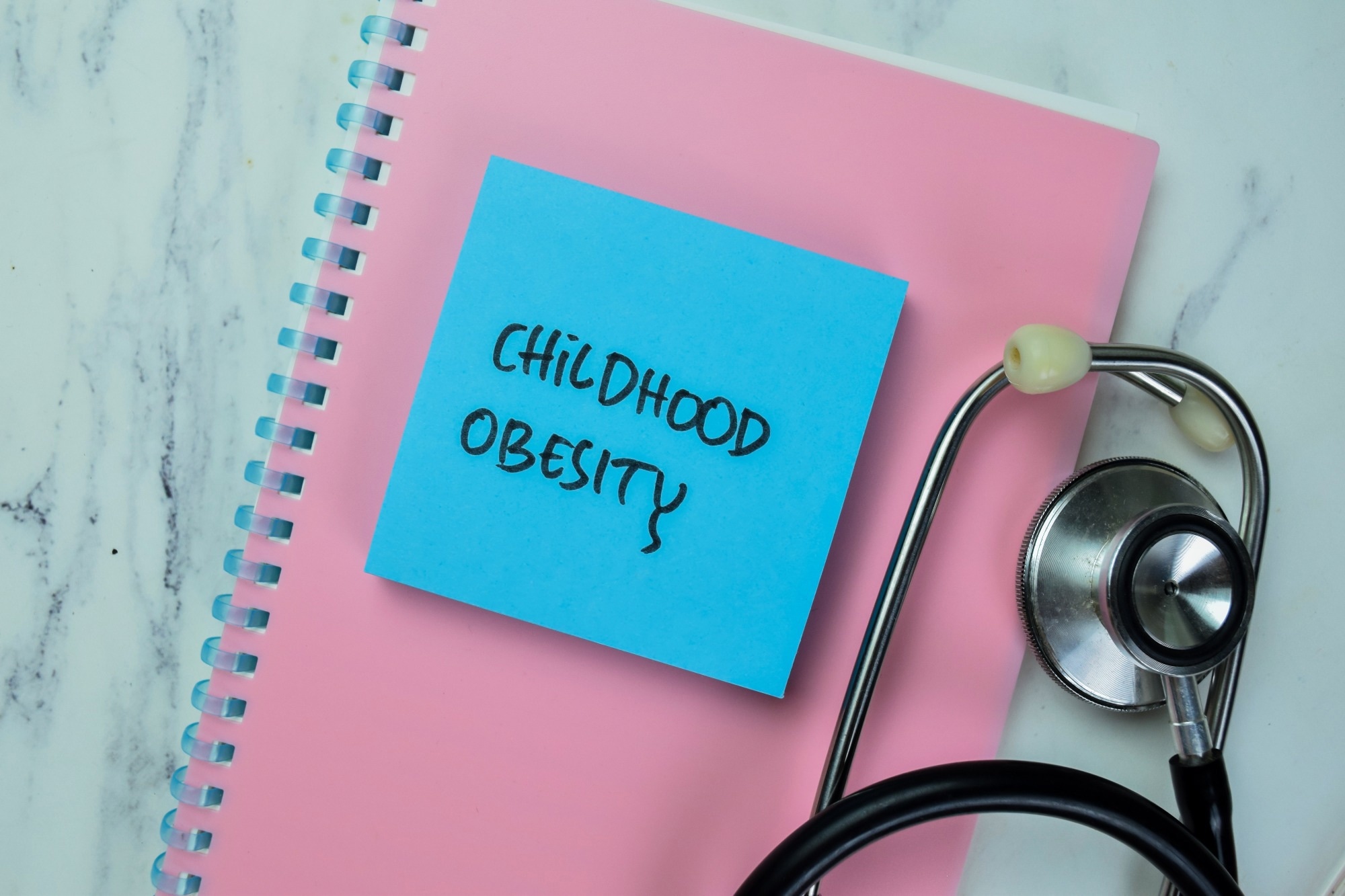 Notebook with sticky note saying childhood obesity